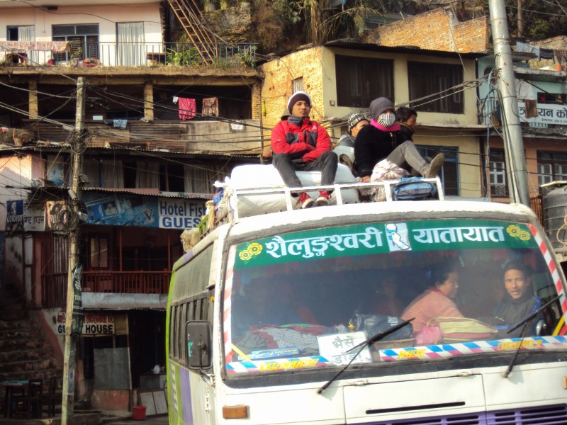 Egy átlagos buszút Nepálban. A helyi járatokon bevett gyakorlat a busz tetején, biztonsági öv vagy bármilyen egyéb óvintézkedés nélkül utazni. A számos baleset és a törvényi tilalom ellenére ez a rendhagyó közlekedési mód továbbra is érvényben van.